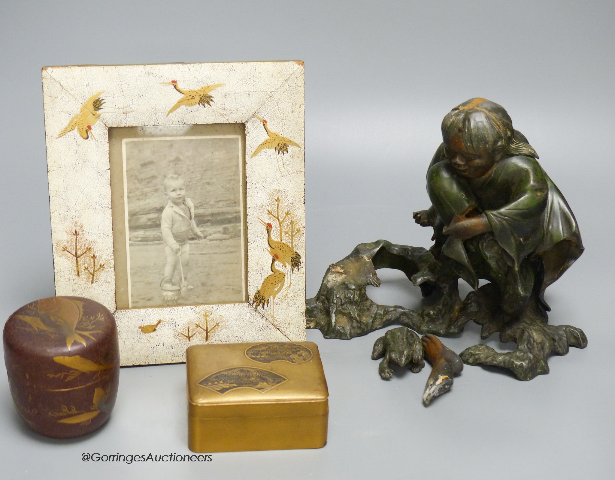 A Japanese lacquer jar and cover, a box and cover, a photo frame,22 x 18cm and an antimony figure of Gama Senin